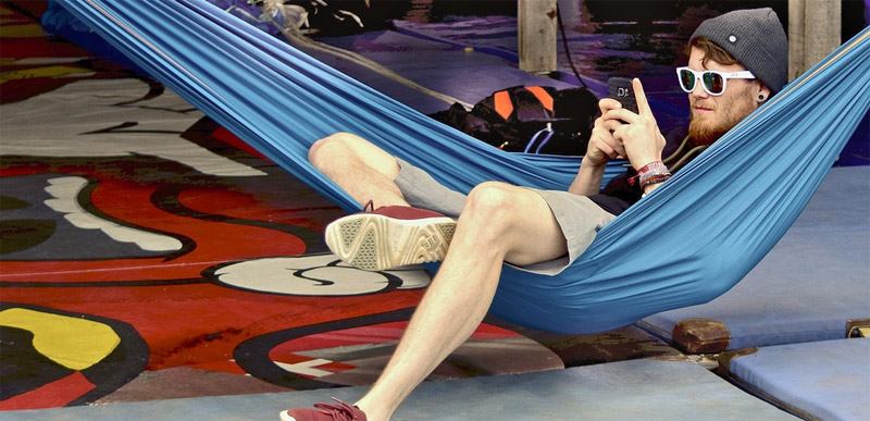 Teen taking survey on phone while sitting on hammock