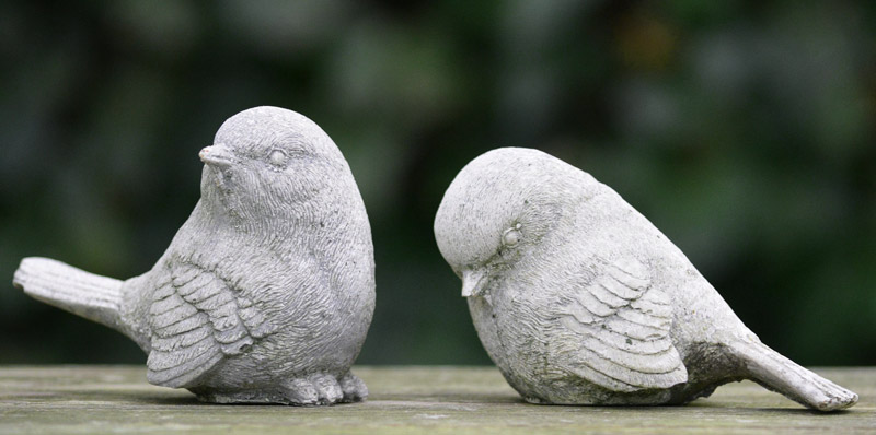 bird figurine ignoring another bird