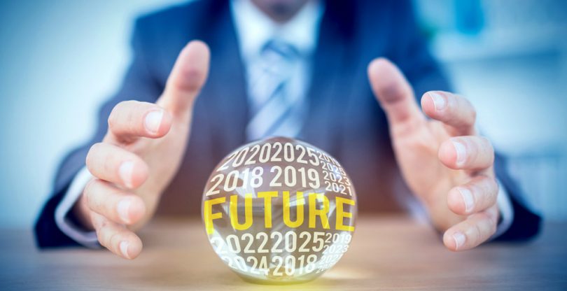 man using crystal ball to forecast future of surveys