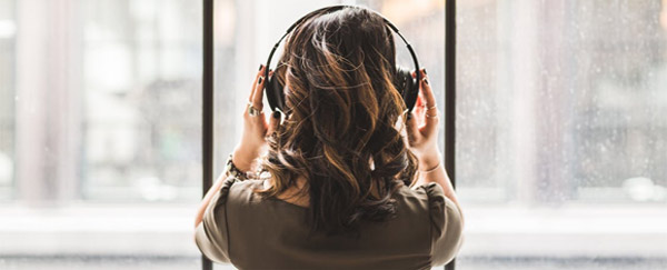woman listening to music looking out window