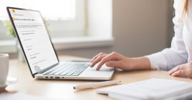 Woman taking diary survey on her laptop