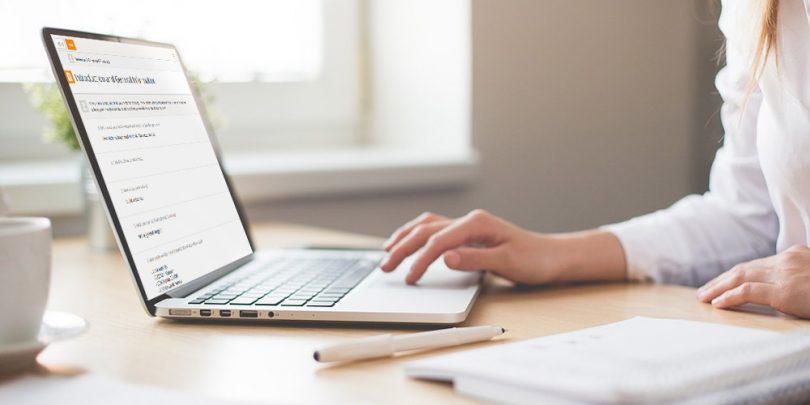 Woman taking diary survey on her laptop