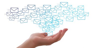 Woman holding out hand with postal letters above