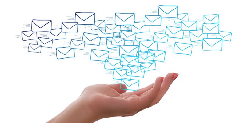 Woman holding out hand with postal letters above