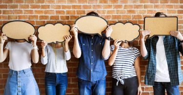 focus group participants holding comment bubbles over their faces