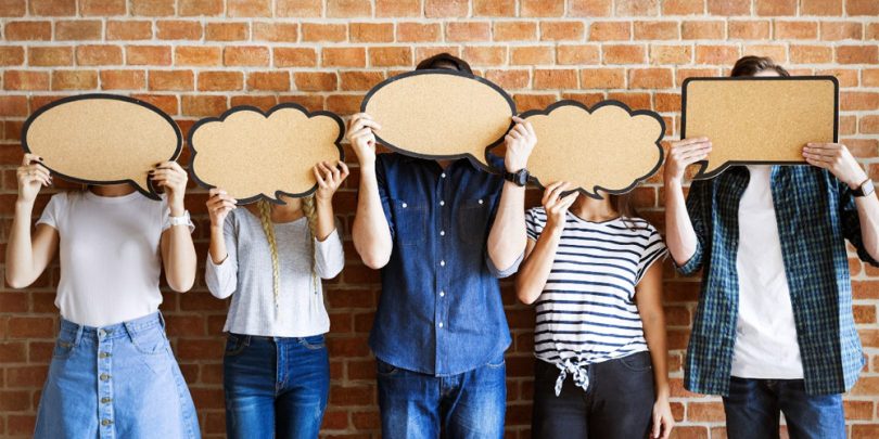 focus group participants holding comment bubbles over their faces