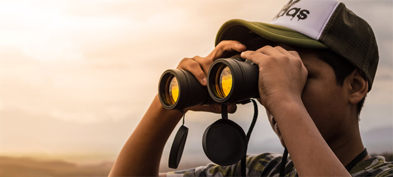 Man using binoculars for searching