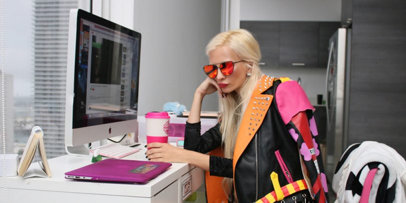 Fabulously dressed woman sitting at computer taking surveys