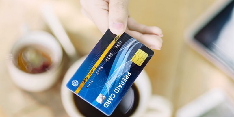 Woman's Hand Holding Prepaid Visa Card