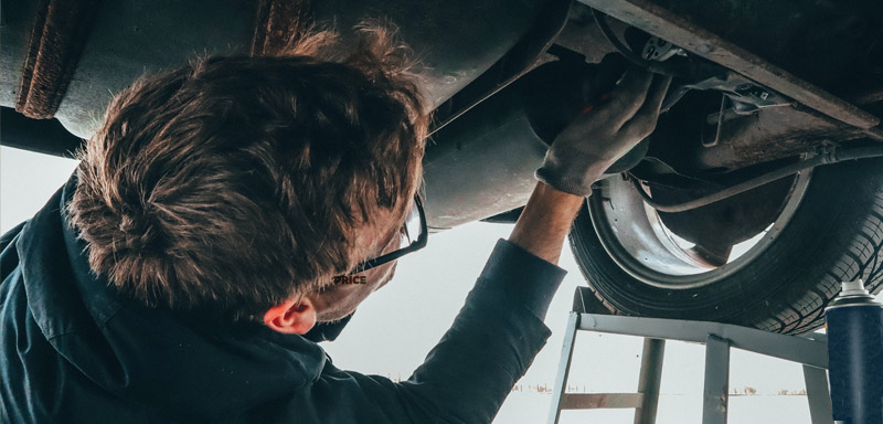 Man doing oil change on car