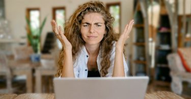 Survey taker sitting in front of computer