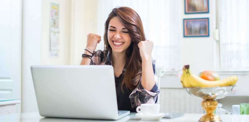 Happy woman using laptop