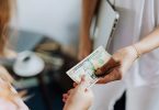 Market research participant receiving a $10 bill