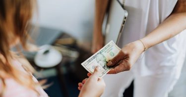 Market research participant receiving a $10 bill