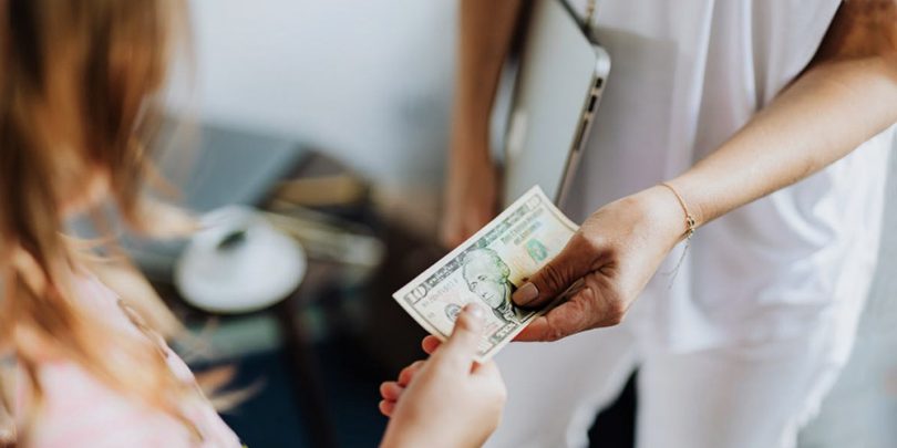 Market research participant receiving a $10 bill