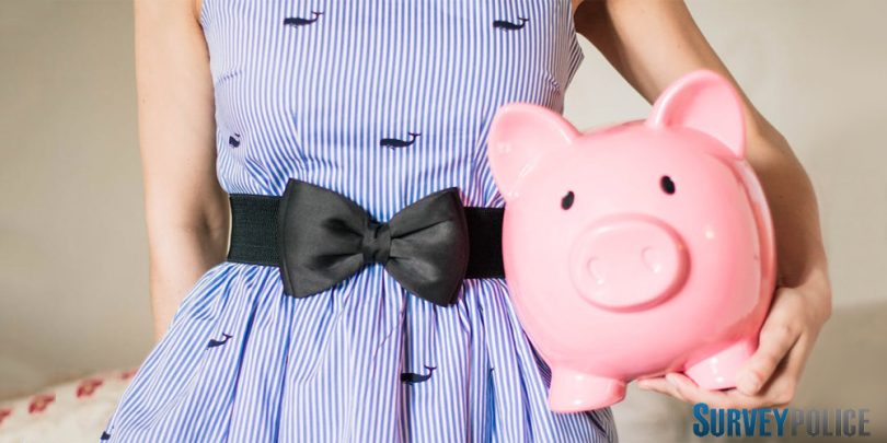 Woman holiding pink piggy bank