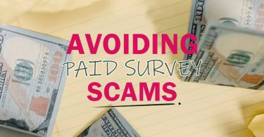 Avoiding paid surveys scams text on top of notebook with money